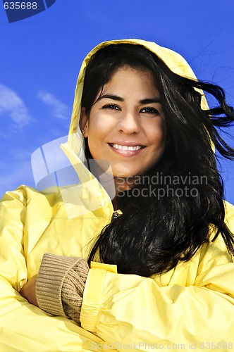 Image of Beautiful young woman in raincoat