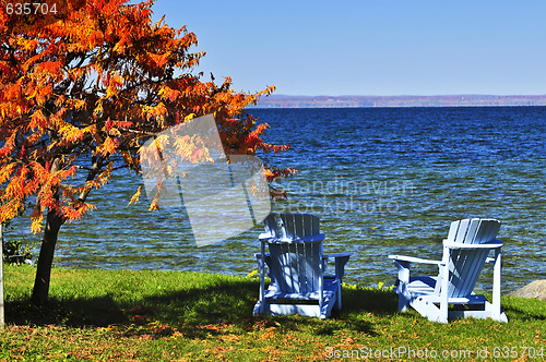 Image of Wooden chairs on autumn lake