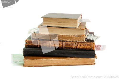 Image of Stack of old books with banknote bookmarks isolated 