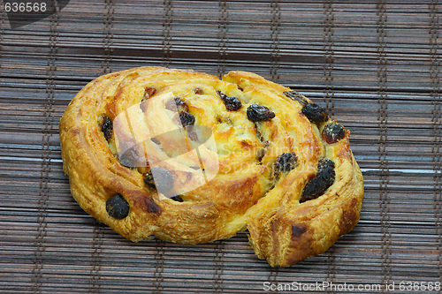 Image of Freshly baked cinnamon roll on bakery paper 