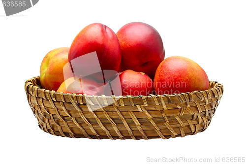 Image of Basket full of fresh peaches isolated on white background