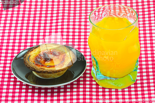 Image of glass of orange juice and cake