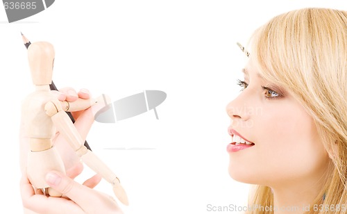 Image of happy teenage girl with wooden model dummy