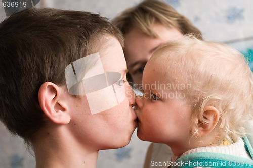 Image of elder brother kisses little sister