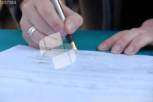 Image of Businessman is signing a contract