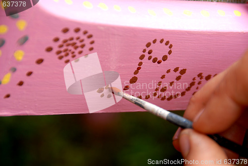 Image of hand with a brush