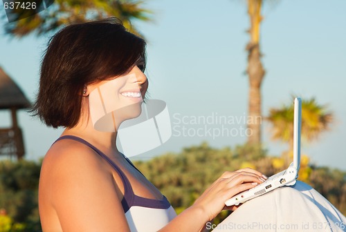 Image of lovely woman with laptop computer