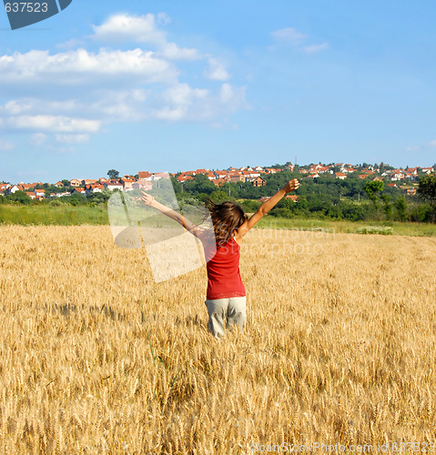 Image of Happy girl jumping in wheat field