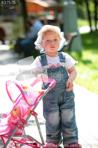 Image of small girl in jeans overalls