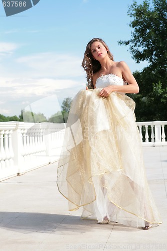 Image of beautiful bride in golden dress