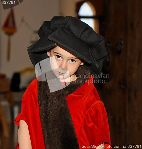 Image of Serious cute little boy in medieval costume standing 