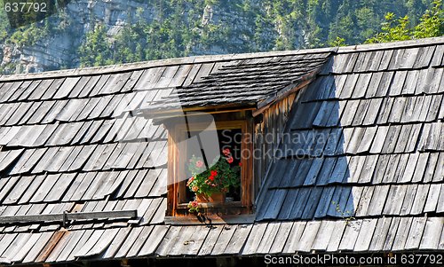 Image of Old wooden tiled roof of Alpine house with attic 