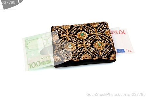 Image of Embroidered woman purse and euro banknotes isolated