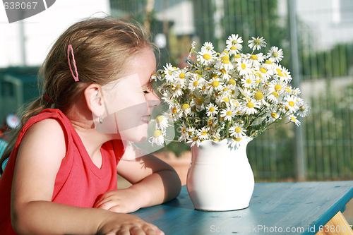 Image of Little girl with chamomile