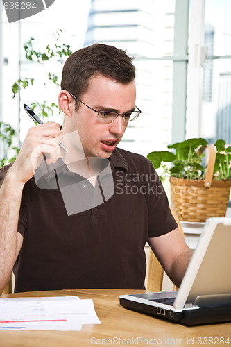 Image of Confused man paying bills