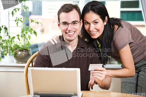 Image of Happy couple shopping online