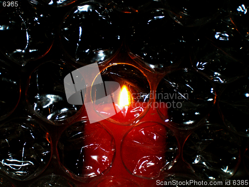 Image of candle light over bubbles