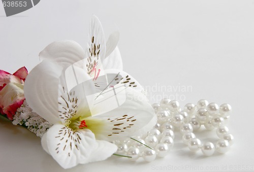 Image of pearl necklace and silk flowers