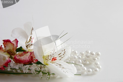 Image of pearl necklace and silk flowers