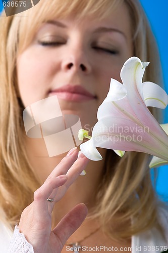 Image of beautiful girl smelling madonna lily