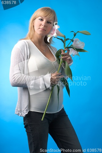 Image of happy pregnant woman with flower