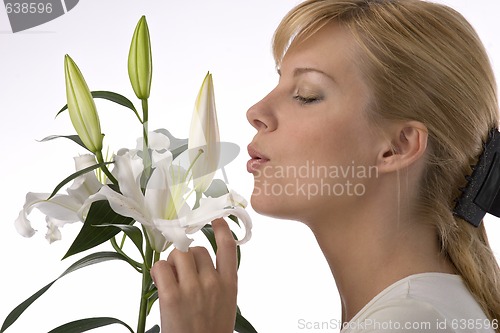 Image of beautiful girl smelling madonna lily