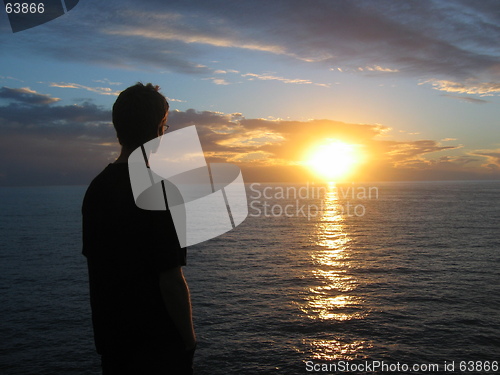 Image of Man looking at sunset