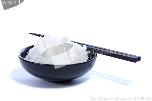 Image of Black bowl with white rice and chop sticks