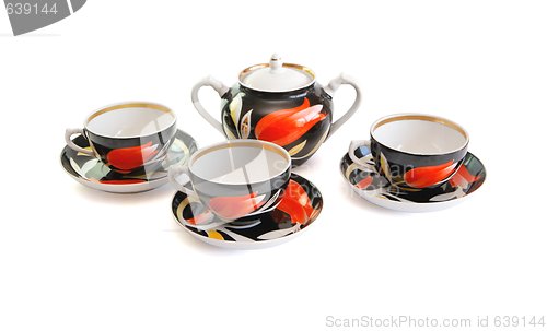 Image of Black tea service  of three cups and sugar basin isolated 