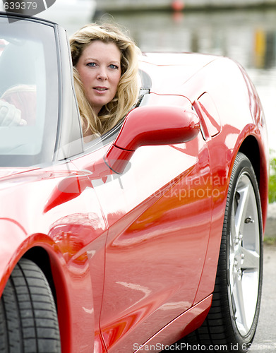 Image of sexy woman in red sports car