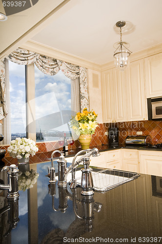 Image of kitchen in city apartment with skyline views