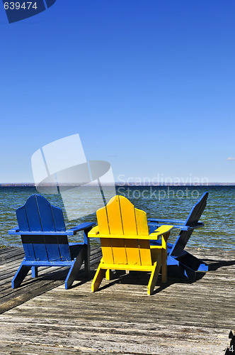 Image of Chairs on wooden dock at lake