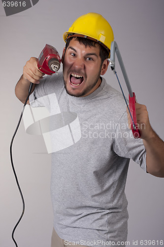 Image of Worker with the saw and drill