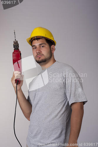 Image of Cool worker with protective helmet and drill