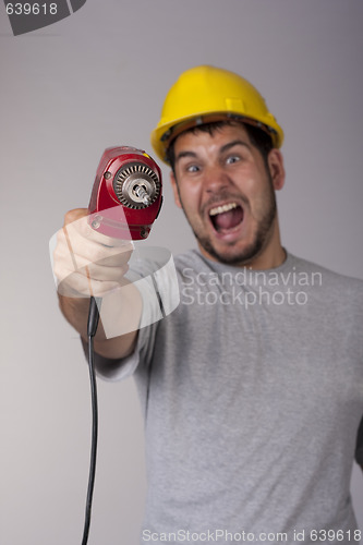 Image of Freakish worker with protective helmet and drill