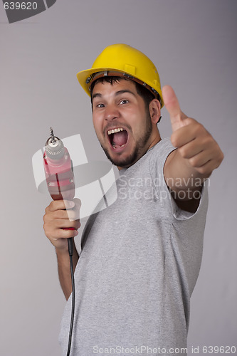 Image of Happy worker with protective helmet and drill