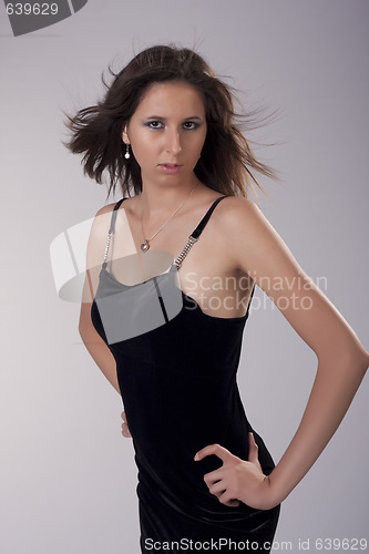 Image of ashion brunette woman wearing black dress