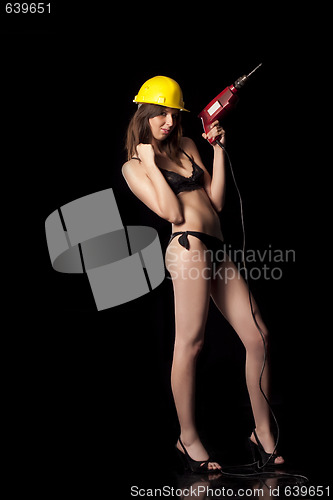 Image of Attractive sexy woman in lingerie with yellow protective helmet and drill