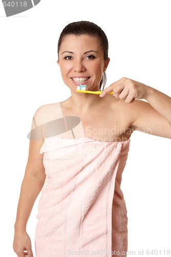 Image of Woman female in towel  brushing teeth
