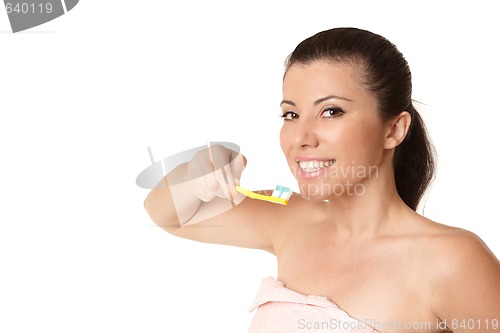 Image of Female holding a toothbrush with toothpaste