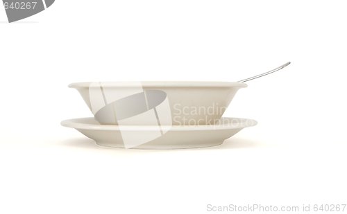 Image of Plain beige soup plate with spoon and saucer side view isolated