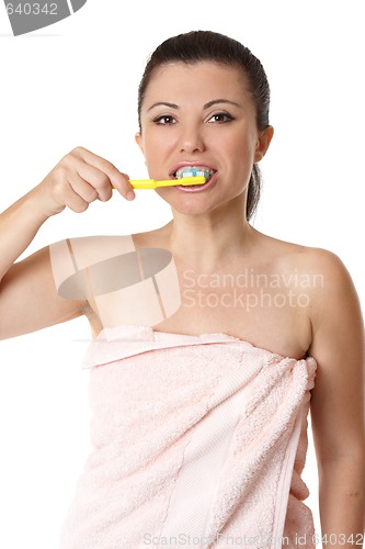 Image of Female brushing her teeth with tooshpaste and toothbrush