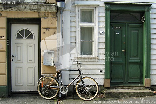 Image of Bicycle parked between two doors