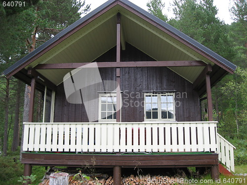 Image of Cabin with a white fence