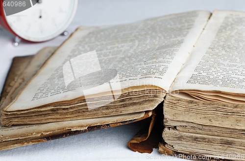 Image of Old book and analog clock.