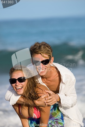 Image of happy smiling young couple on the beach