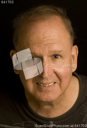 Image of senior man retired head shot portrait in tee shirt