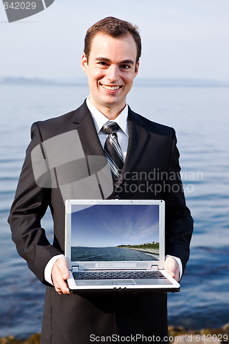 Image of Caucasian businessman with laptop