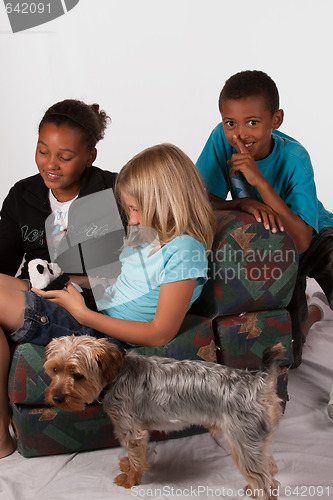 Image of Boy trying to sneak up on sister and friend