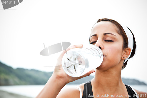 Image of Sporty woman drinking water